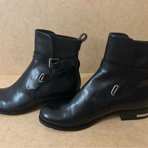 A pair of Blake leather shoes with belts around the ankles. Slip on shoes